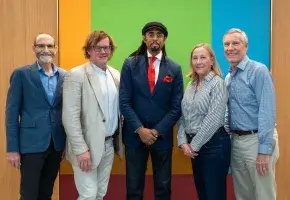 The cochairs of the Commission on Accelerating Climate Action pose with Academy President, David Oxtoby in front of a striped colorful background.