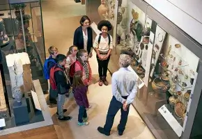 Aerial view of school children visiting a museum gallery. 
