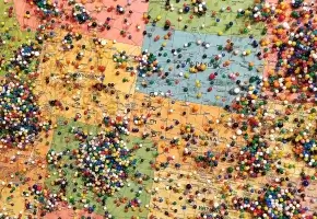 Part of a map of America with a multitude of pins in it. 