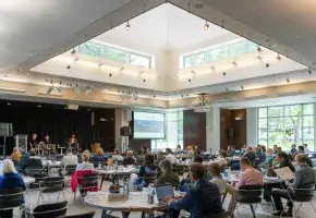 A full room of conference attendees 