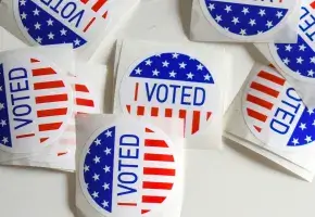 Red white and blue stickers with "I Voted" text on them.