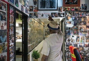 Black Man in His Home surrounded by Images of Family and History