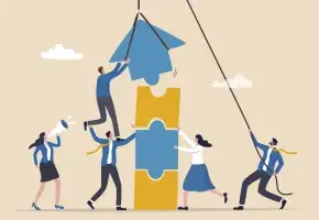 An illustration of five people collaborating to place puzzle pieces together, with one person using a rope to lift a large blue puzzle piece atop a yellow one.