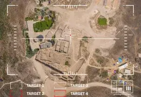 A view from a drone of land below with target and weapon outlines. 
