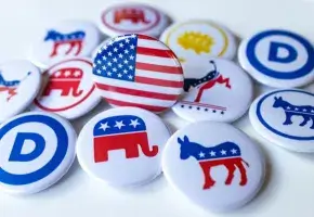 American flag button surrounded by buttons with party insignia.