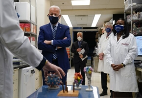 Dr. Barney Graham, left, speaks as President Joe Biden listens during a visit to the Viral Pathogenesis Laboratory at the National Institutes of Health (NIH), Thursday, Feb. 11, 2021, in Bethesda, Md. Kizzmekia Corbett, an immunologist with the Vaccine Research Center at the NIH, right, and NIH Director, second from right, listen.