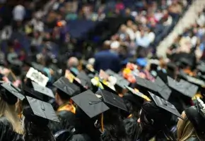 Black mortarboards at a college graduation.