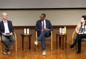 Three speakers in discussion about rebuilding trust in science.