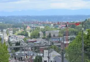 Photo of Tacoma Washington with city in foreground and mountains in the distance.