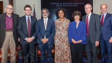Four attendees stand beside the speakers from the event at the Edward M. Kennedy Institute for the United States Senate held to promote the Case for Supreme Court Term Limits report.