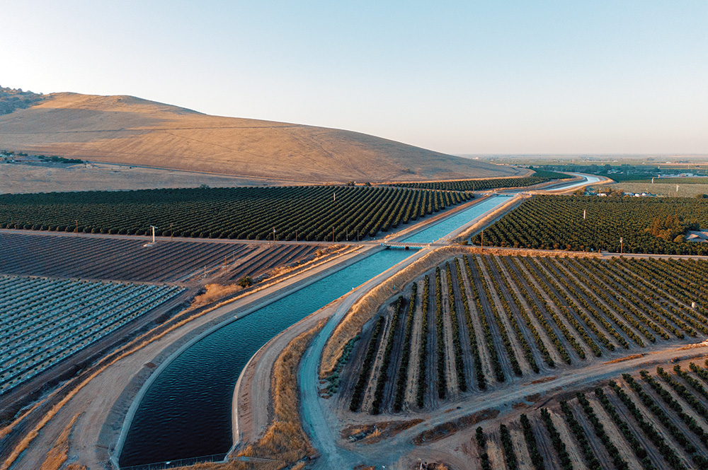 d.	Overhead image of a lush agricultural area, with a river running between fields.