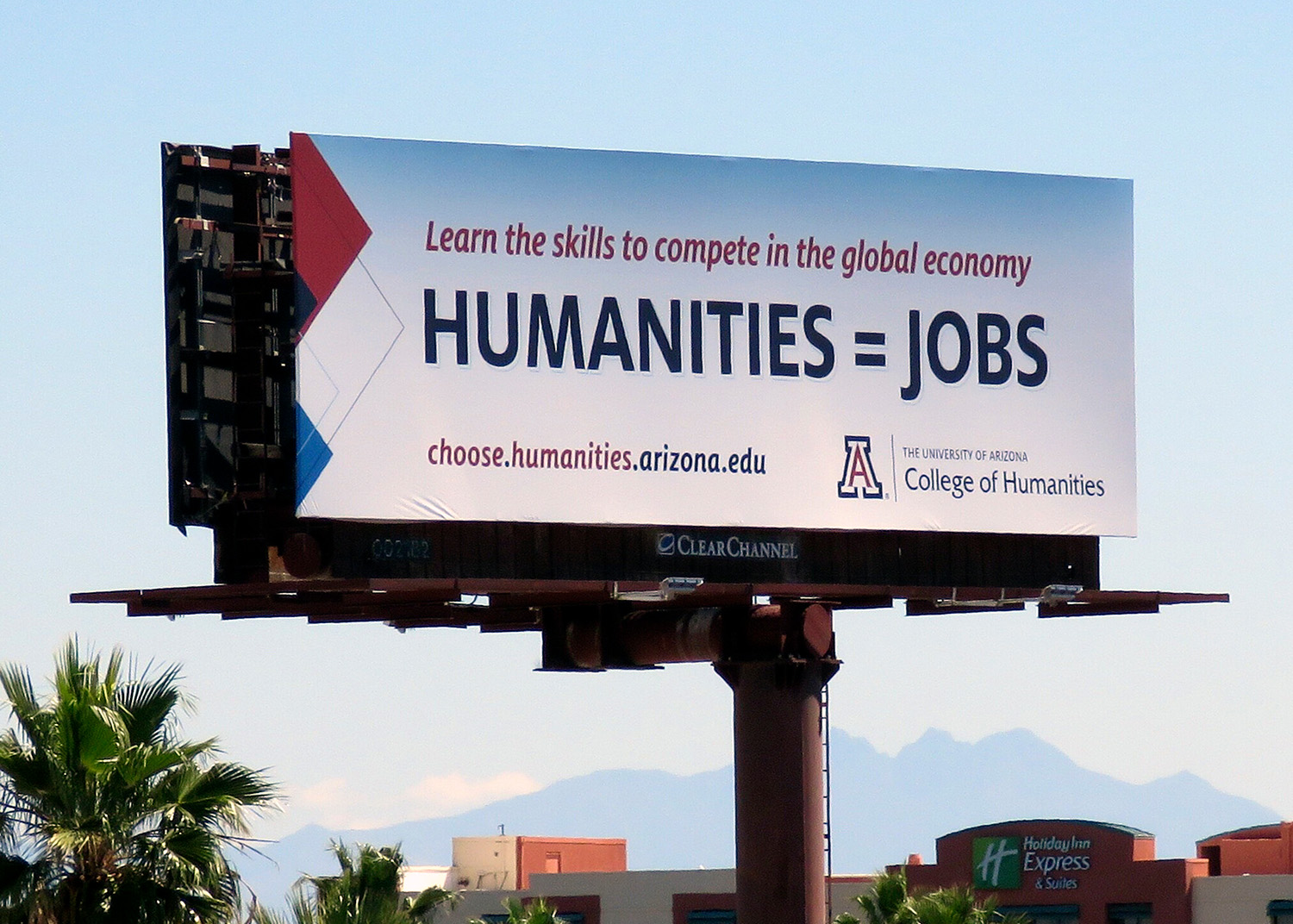 A large billboard advertises a college program in the humanities and equates the humanities with jobs and skills to compete in the global economy.